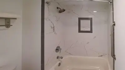 a bathroom with a shower and a white sink at Clarion Pointe El Cajon San Diego East in El Cajon
