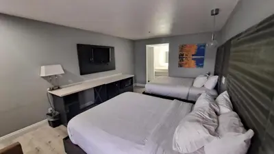 a hotel room with two beds and a tv at Clarion Pointe El Cajon San Diego East in El Cajon