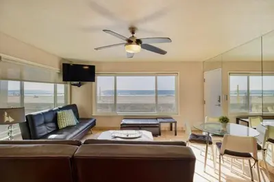 a living room with a couch and a ceiling fan at 102-Luxury2 in San Diego