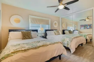 a bedroom with two beds and a ceiling fan at 102-Luxury2 in San Diego