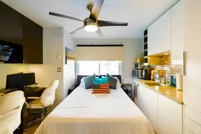 a room with a large white bed in a kitchen at 107-Oceanfront Lux 17 in San Diego
