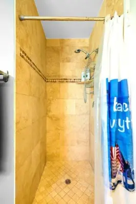 a shower with a shower curtain in a bathroom at 107-Oceanfront Lux 17 in San Diego