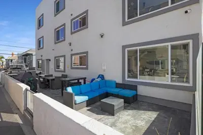 a blue couch sitting outside of a building at 107-Oceanfront Lux 17 in San Diego