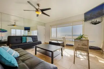 a living room with a couch and a table at 107-Oceanfront Lux 17 in San Diego
