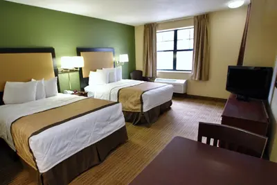 a hotel room with two beds and a flat screen tv at Extended Stay America Suites - Orange County - Lake Forest in Foothill Ranch