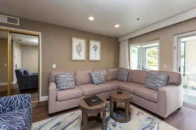 a living room with a couch and a table at Capistrano SurfSide Inn in Capistrano Beach