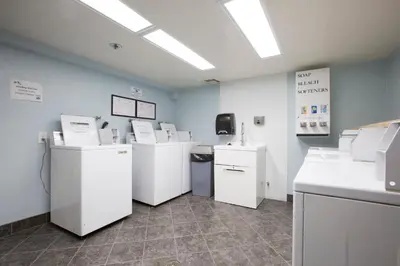 a room with white counters and appliances in a room at Capistrano SurfSide Inn in Capistrano Beach