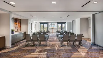 a conference room with chairs and a sign in the background at Ayres Hotel San Diego South - Chula Vista in Chula Vista