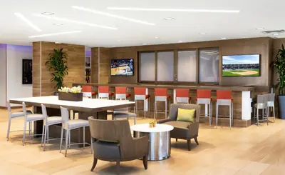a restaurant with a table and chairs and a bar at Ayres Hotel San Diego South - Chula Vista in Chula Vista