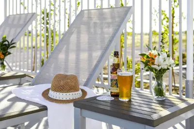 a table with a hat and a glass of beer at Ayres Hotel San Diego South - Chula Vista in Chula Vista
