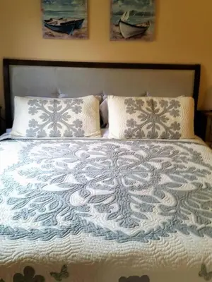 a large bed with two pillows and a blanket at Castlegate Guest Apartment in Vista