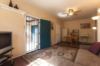 a living room with a couch and a flat screen tv at Castlegate Guest Apartment in Vista