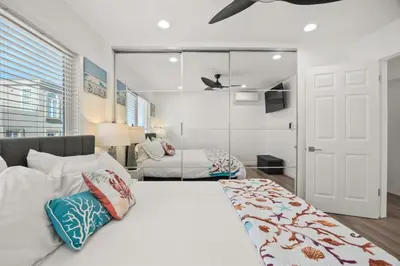 a bedroom with a large white bed with pillows at 103-Luxury3 in San Diego