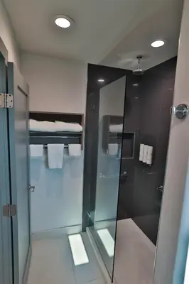 a bathroom with a shower with a glass door at Rodeway Inn San Clemente in San Clemente