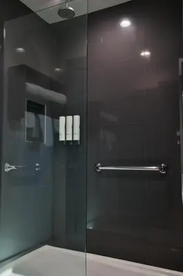 a shower with a glass door in a bathroom at Rodeway Inn San Clemente in San Clemente