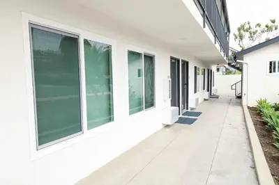 a hallway of a white house with windows at Rodeway Inn San Clemente in San Clemente