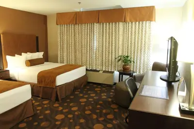 a hotel room with two beds and a desk at Best Western Plus Suites Hotel Coronado Island in San Diego