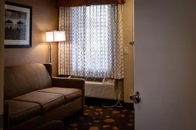 a hotel room with a couch and a window at Best Western Plus Suites Hotel Coronado Island in San Diego