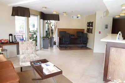 an open living room with a desk and chairs at Best Western Plus Suites Hotel Coronado Island in San Diego