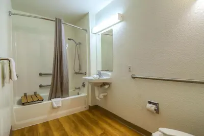 a bathroom with a shower and a sink and a toilet at Motel 6-Chula Vista, CA - San Diego in Chula Vista