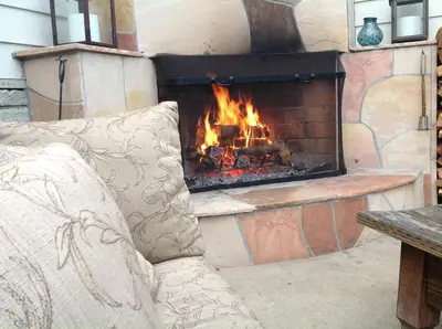 a fireplace with a couch in front of it at The Tides Laguna Beach in Laguna Beach