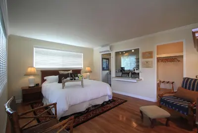a bedroom with a bed and a couch and a chair at The Tides Laguna Beach in Laguna Beach