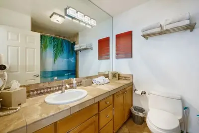 a bathroom with a sink and a toilet and a mirror at 108-Ocean Front Combo in San Diego