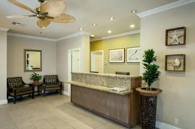 a lobby with a reception desk and a ceiling fan at Pacific Shores Inn in San Diego