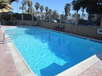 a large swimming pool with blue water at Pacific Shores Inn in San Diego