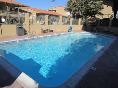 a large swimming pool with blue water at Pacific Shores Inn in San Diego