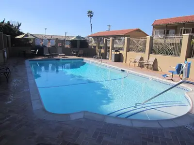 a large swimming pool with blue water at Pacific Shores Inn in San Diego