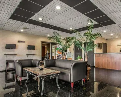 a waiting room with leather chairs and a table at Quality Inn Temecula Valley Wine Country in Temecula