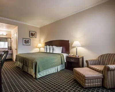 a hotel room with a bed and a chair at Quality Inn Temecula Valley Wine Country in Temecula