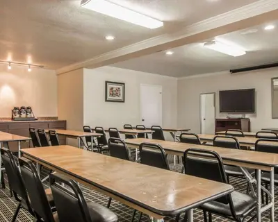 a room with tables and chairs and a flat screen tv at Quality Inn Temecula Valley Wine Country in Temecula