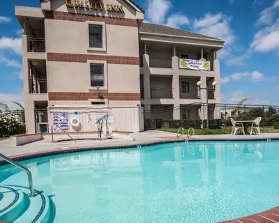 a hotel with a swimming pool in front of a building at Quality Inn Temecula Valley Wine Country in Temecula