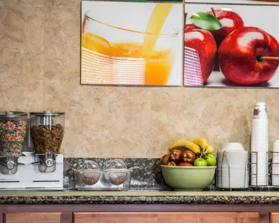 a kitchen counter with a bowl of apples and oranges at Quality Inn Temecula Valley Wine Country in Temecula