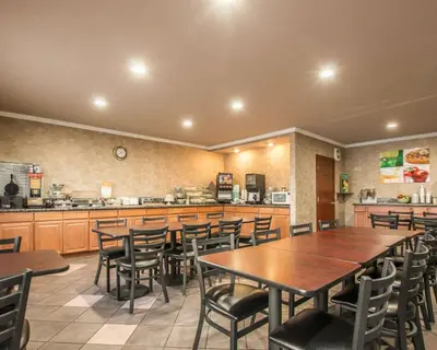 a restaurant with tables and chairs and a kitchen at Quality Inn Temecula Valley Wine Country in Temecula