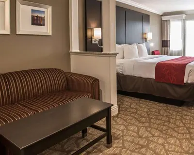a hotel room with a bed and a couch at Comfort Suites San Clemente Beach in San Clemente