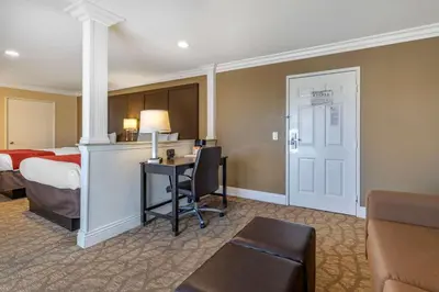 a hotel room with a bed and a desk at Comfort Suites San Clemente Beach in San Clemente