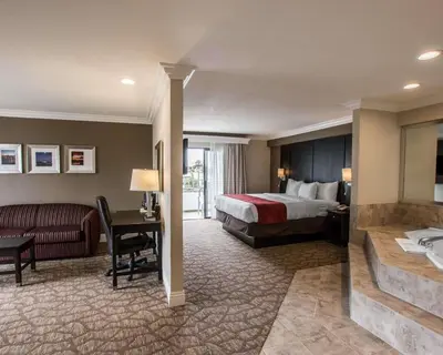 a hotel room with a bed and a desk at Comfort Suites San Clemente Beach in San Clemente