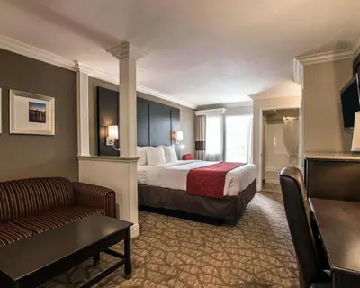 a hotel room with a bed and a couch at Comfort Suites San Clemente Beach in San Clemente