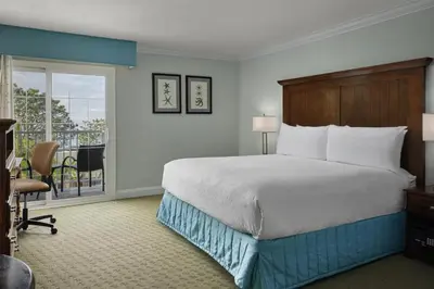 a hotel room with a bed and a balcony at Best Western Premier Hotel Del Mar in San Diego