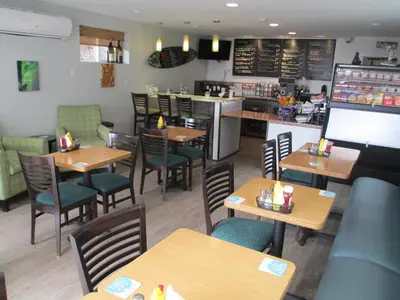 a restaurant with wooden tables and chairs and a counter at Best Western Premier Hotel Del Mar in San Diego