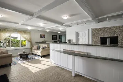 a living room with a bar with a couch and a television at Best Western Premier Hotel Del Mar in San Diego