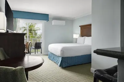 a hotel room with a bed and a table at Best Western Premier Hotel Del Mar in San Diego