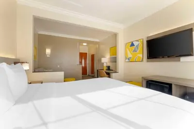 a hotel room with a large bed and a flat screen tv at Comfort Suites Oceanside Camp Pendleton Area in Oceanside