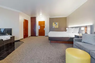 a large hotel room with a bed and a couch at Comfort Suites Oceanside Camp Pendleton Area in Oceanside
