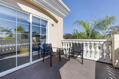 a balcony with a table and chairs on it at Comfort Suites Oceanside Camp Pendleton Area in Oceanside