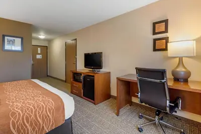 a hotel room with a bed and a desk and a computer at Comfort Inn & Suites Murrieta Temecula Wine Country in Murrieta
