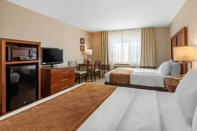 a hotel room with two beds and a flat screen tv at Comfort Inn & Suites Murrieta Temecula Wine Country in Murrieta